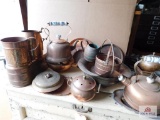 Group of copper kettles, cups, and bowl