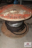 Wooden spool with half inch braided steel cable
