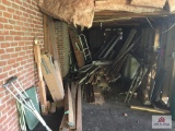 Contents underneath deck: wood, bicycles, door, etc.