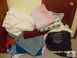 pile of miscellaneous blankets n quilts