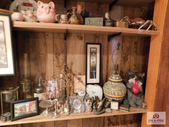 Contents of shelves collection of decorative items - candleholders, lamp, piggy banks, small clocks