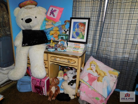 Various room decorations, stuffed animals, desk and some books