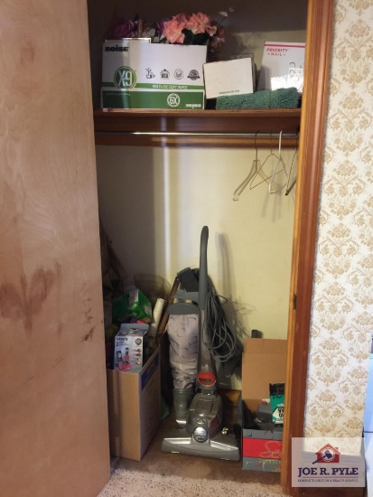 Contents of closet: Kirby sweeper with attachments, decorator, etc.