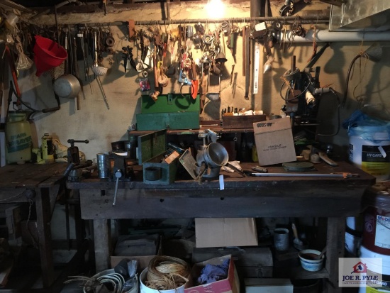 Work bench and contents and all item hanging on pipe above bench