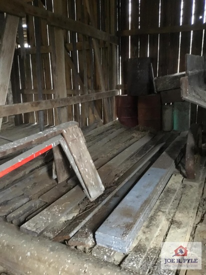 Lot of wood, saw horses, and barrels