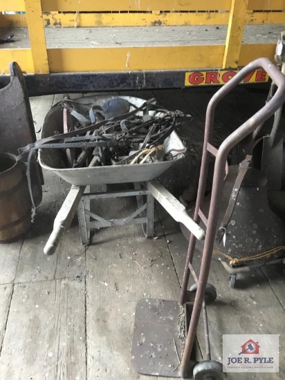 Early horse bridles and bit in wheel barrow and vintage hand truck