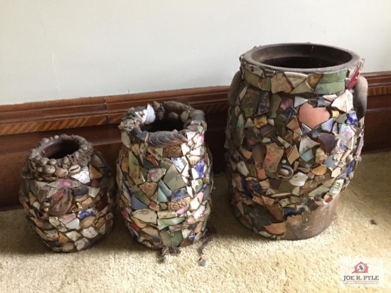 Three stoneware crocks decorated with broken china pieces