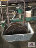 Metal bin with metal tractor seats and hay cradle