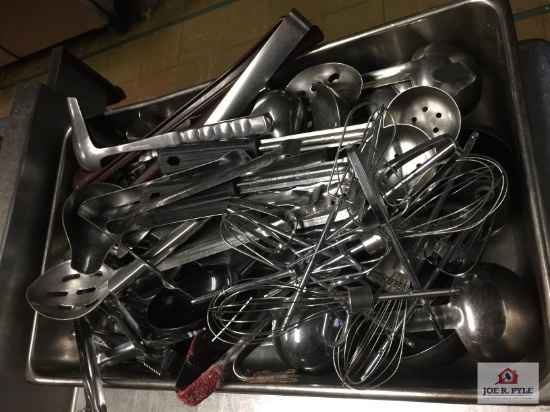 Lot of stainless restaurant utensils