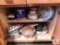 Contents of kitchen cabinet: tins and pressure cooker