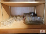 Two cabinets of glassware, snack trays and cut glass items