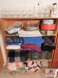 Shelf and contents of throws, glasses, dishes and tins
