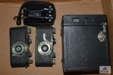 Box camera, 2 Leitz cameras, and a small pair of binoculars (all in poor condition)