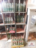 Shelves and collection of coke bottles