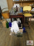 Table, baskets, bottles, chair and linens