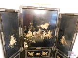 Black lacquered screen w/ raised d?cor of warriors measuring 6.5'x6'
