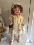 Antique composition girl doll unmarked in tagged Madame Alexander outfit