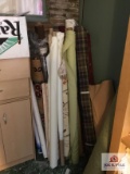 Lot of bolt fabric in corner and fabric on top of cabinets