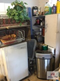 Contents in corner of garage: white wood cabinet, wire baskets, fluids, etc.