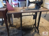 Vintage industrial Singer sewing machine with treadle