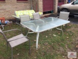 Glass top metal table with 4 chairs