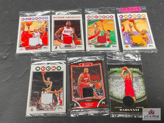 Lot of 7 NBA game worn jersey insert cards that are still sealed in original cellophane packaging.