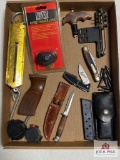 Flat of miscellaneous sportsmans items: knives, bow release, bow site, etc.