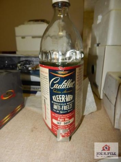 Original washer bottle w/ bracket out of Cadillac
