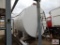 Large white 10,000-gallon tank on skids