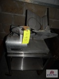 Hobart Commercial meat slicer on stainless steel stand