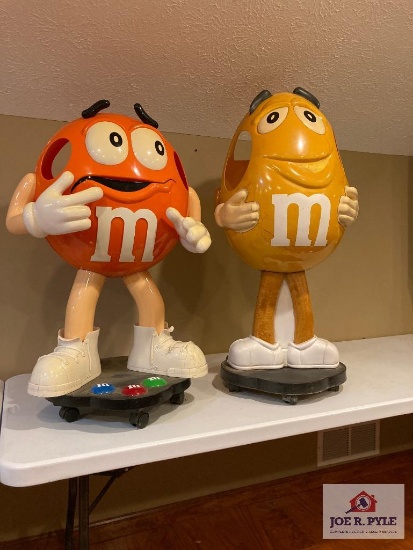 2 M & M store displays on wheels Orange 37" x 24" x 17" and yellow 41" x 18" x 17"