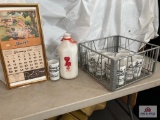 Islay's calendar, glasses, milk bottle, metal carrier