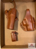[302] Two brown leather holsters and a mag pouch
