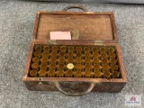 [299] Brass shotshells an loading implements in a wooden kit box