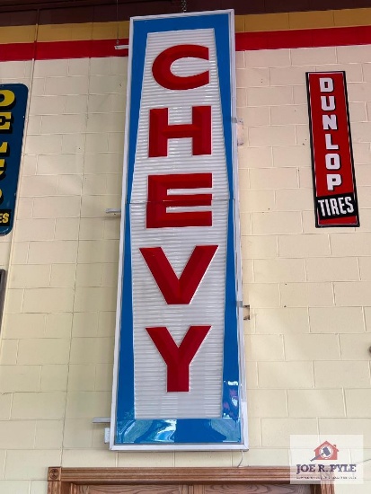 Large lighted vertical Chevy sign