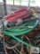 Assortment of hoses on wire shelf