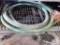 Green discharge hose on metal shelf