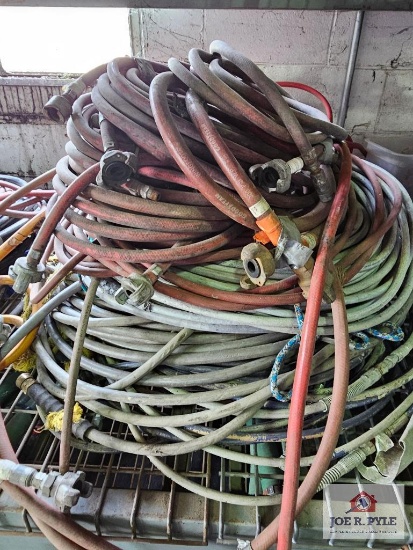 Assortment of hoses on wire shelf