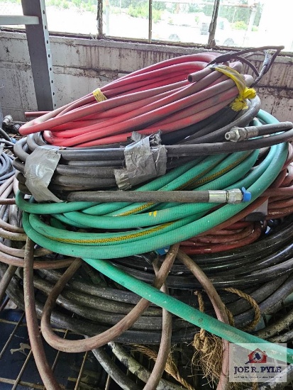 Assortment of hoses on wire shelf