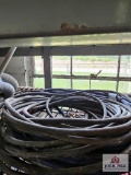 Assortment of extension cords and wire on metal shelf