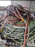 Assortment of hoses on wire shelf