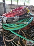 Assortment of hoses on wire shelf