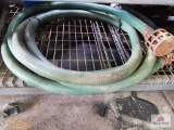 Green discharge hose on metal shelf