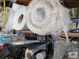 2 shelves of roll fiberglass and rolls of plastic
