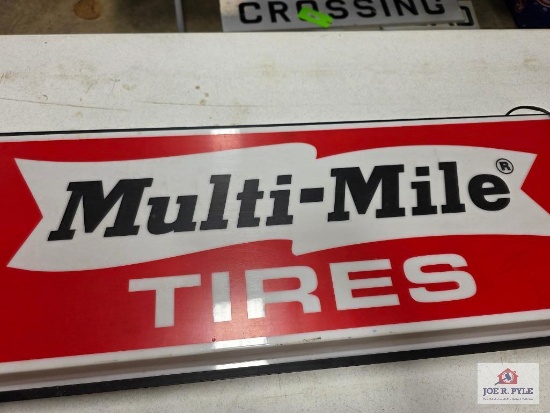 Multi-Mile Tires light-up sign and a wooden picture frame