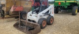 BOBCAT 863 SKID LOADER WITH BUCKET AND HAY FORKS