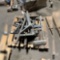 PALLET OF MISC HITCHES , WHEEL CHALKS,POST DRIVERS