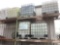 7 PLASTIC LIQUID STORAGE CONTAINERS WITH METAL PALLET WITH CAGES,