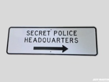 SECRET POLICE HEADQUARTERS TIN SIGN, 36" X 12"