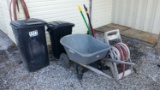 (2) Trash cans, Wheel barroe, Gardenhoes (3) brooms